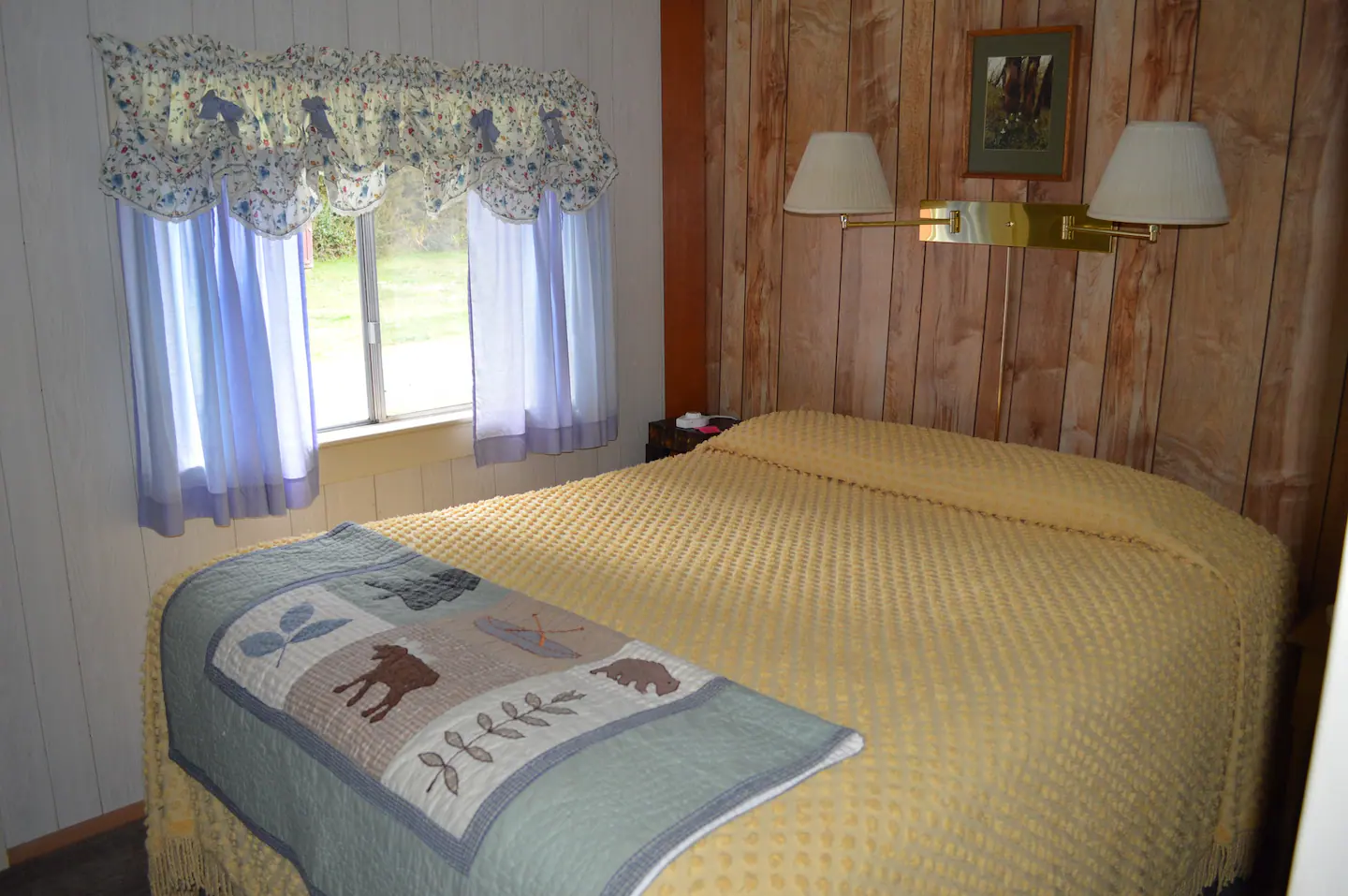 The north bedroom includes a queen bed, heated mattress pad, small chest of drawers, and a tiny closet.