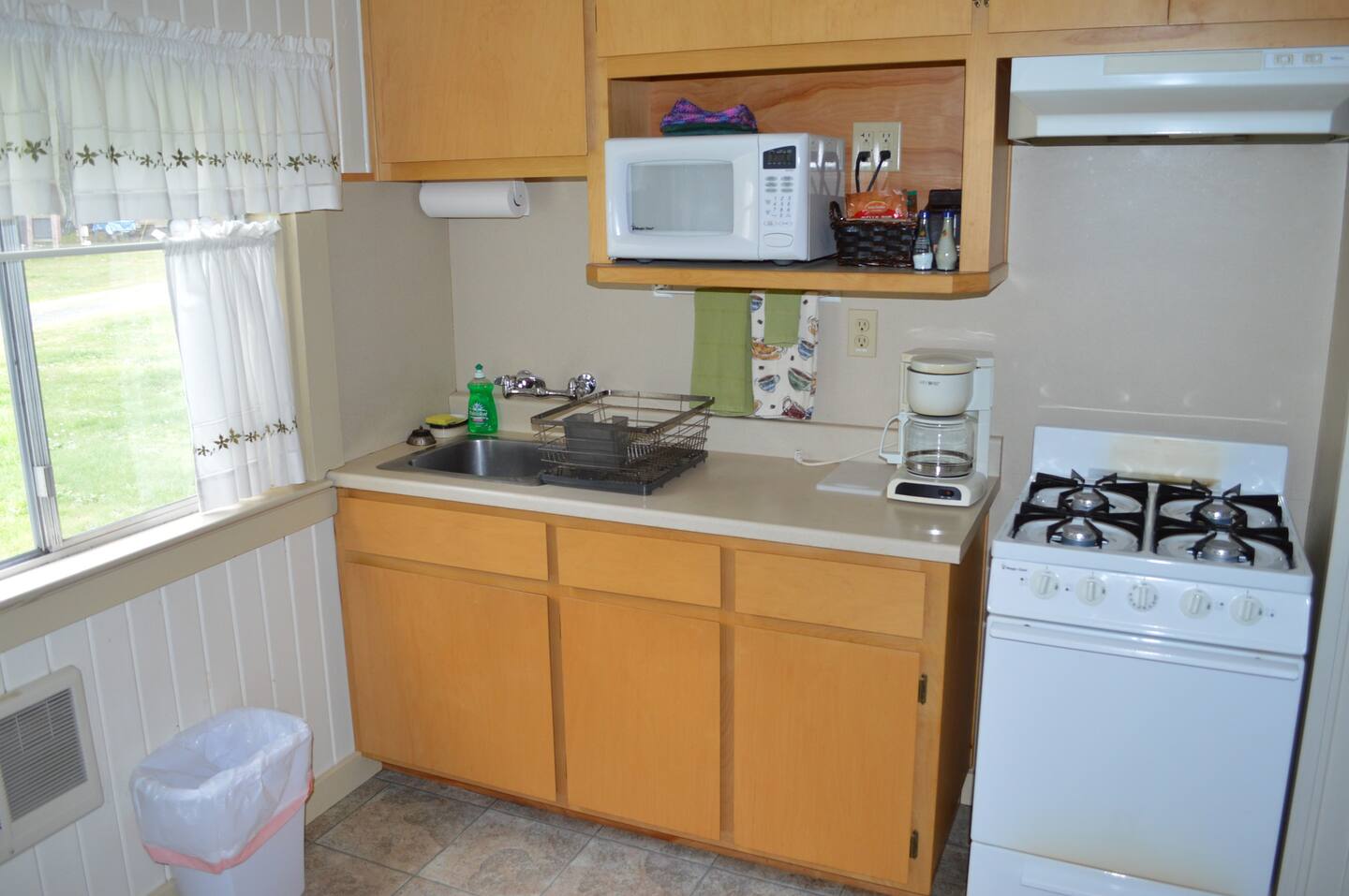 The kitchen, which adjoins the living space has a full fridge, microwave, small range oven, toaster, and coffee maker.